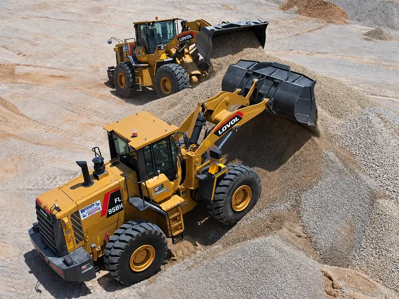 Two yellow WNR wheel loaders working a gravel stockpile in a quarry