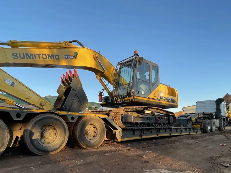 WNR lowbed trailer carrying an excavator in the yard