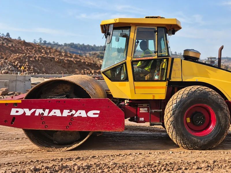 Red and yellow WNR smooth drum roller on a Gauteng earthworks site
