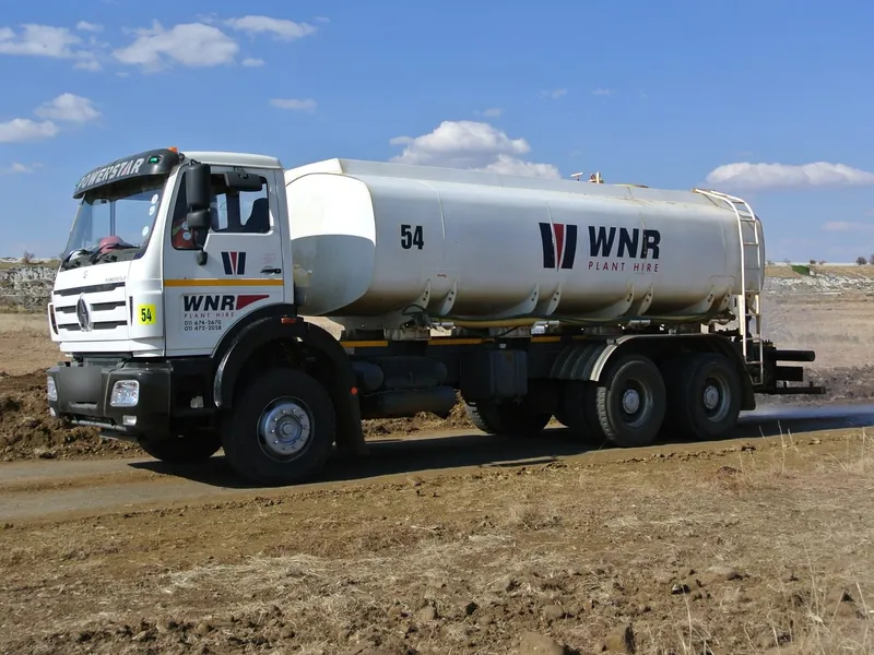 White WNR Plant Hire water truck on a dirt site road