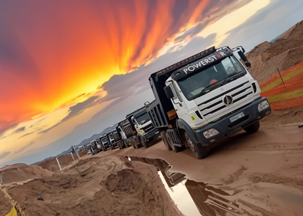 Line of WNR tipper trucks on a site at sunset