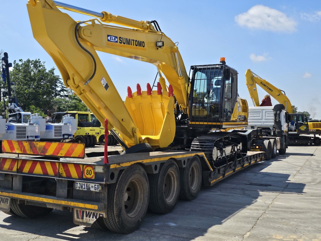 WNR lowbed transporting an excavator, with a second loaded lowbed behind