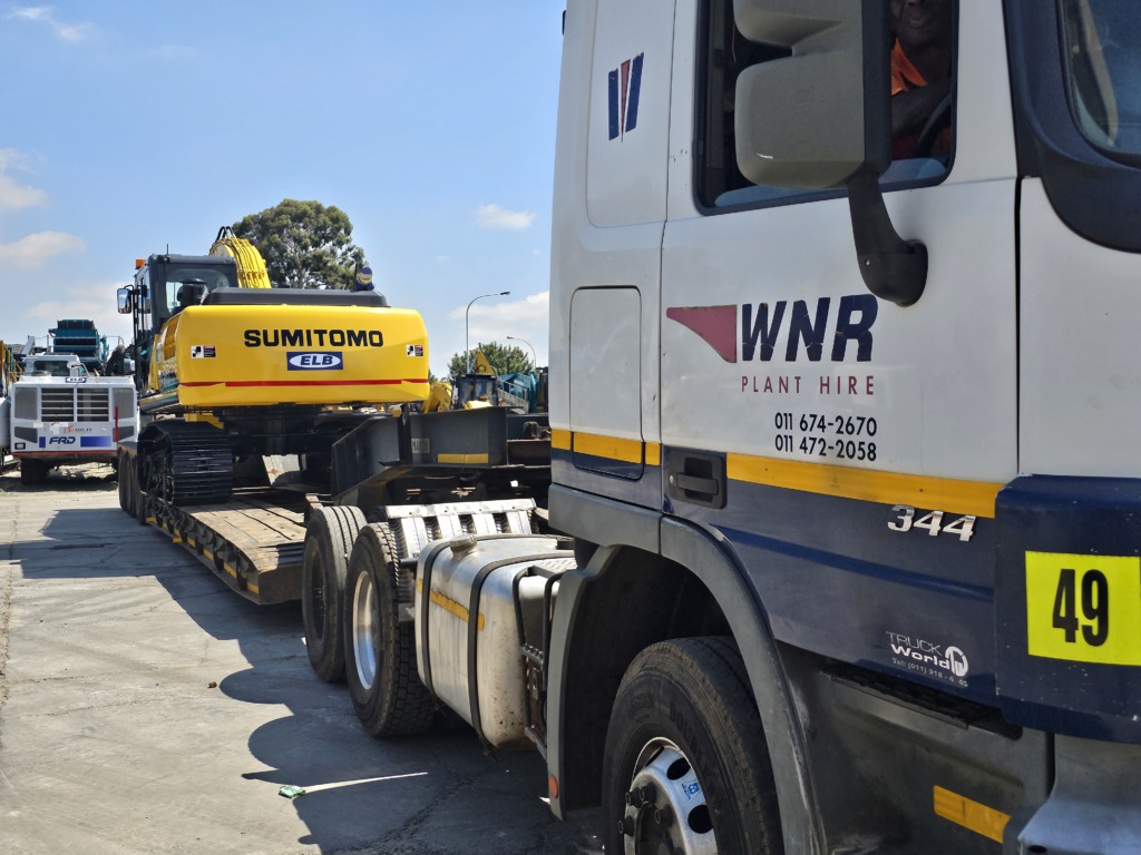 WNR truck and lowbed trailer loaded with an excavator