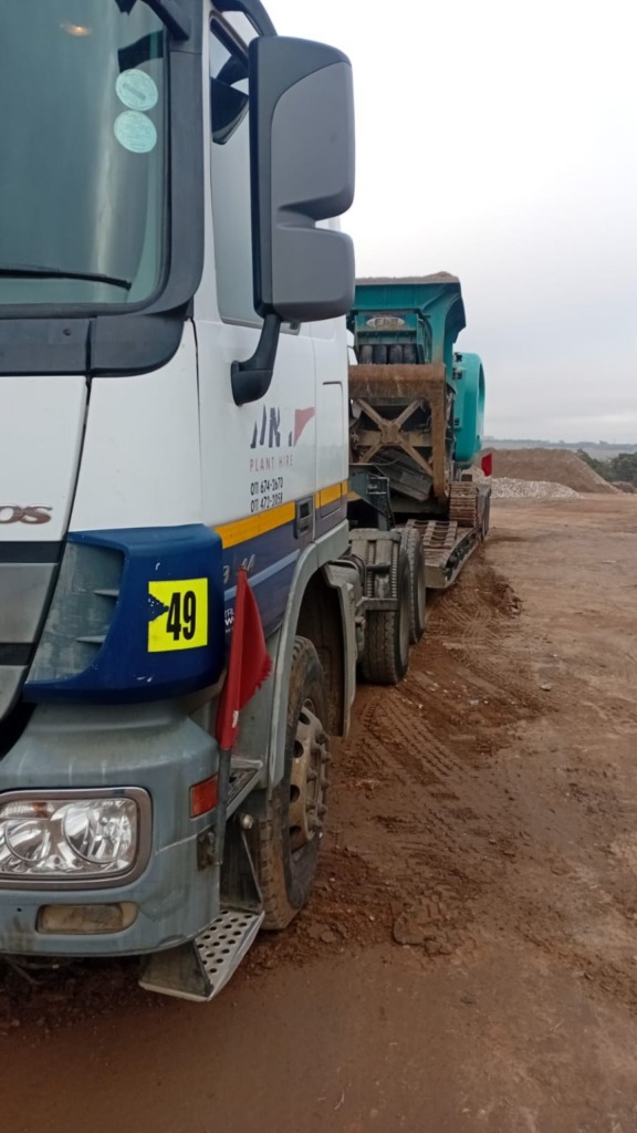 WNR lowbed truck delivering a machine to site